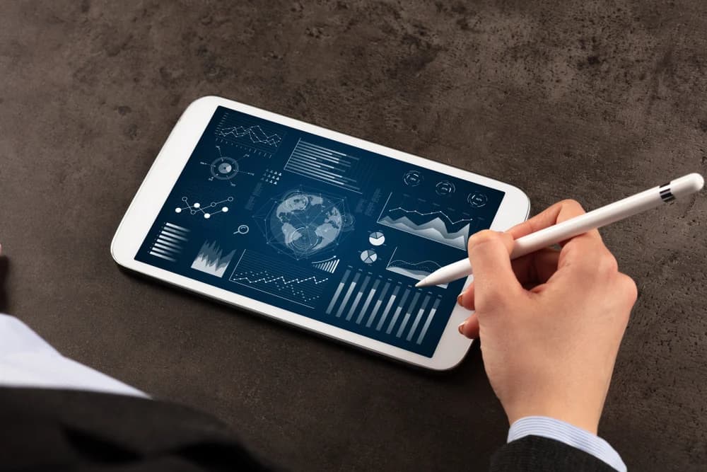 Person reviewing charts on a tablet.