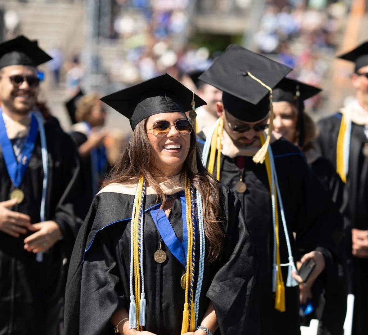 Graduates wearing caps and gowns at a commencement ceremony.